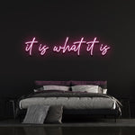 It Is What It Is LED Neon Sign in bright pink, a stylish and trendy addition for home, office, or gifting, featuring long-lasting LED lights.