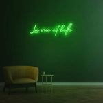 La Vue Est Belle LED Neon Sign with green light, perfect for optical stores or adding charm to your home decor.