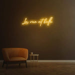 La Vue Est Belle LED Neon Sign with vibrant yellow light, designed to add warmth and beauty to any room or event.