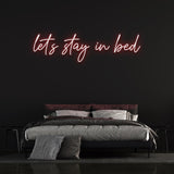Cozy 'Let's Stay in Bed' LED neon sign for a relaxed and inviting bedroom ambiance.