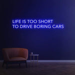 Bright and stylish 'Life Is Too Short To Drive Boring Cars' neon sign for automotive wall decor.