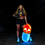 Woman holding a vibrant "Chill Pill" neon artwork, showcasing a bold and modern design for artistic decor and ambient lighting.