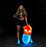 Woman holding a vibrant "Chill Pill" neon artwork, showcasing a bold and modern design for artistic decor and ambient lighting.