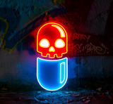 Skull and pill-shaped neon sign glowing in red and blue, placed against a graffiti wall for a trendy and artistic appeal.
