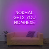 Bright pink 'Normal Gets You Nowhere' LED neon sign, adding a fun and motivating touch to your space, reminding you to embrace individuality and follow your dreams.