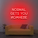 Vibrant red 'Normal Gets You Nowhere' LED neon sign, a powerful statement piece for any room, encouraging ambition and a unique, goal-oriented mindset.
