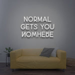 Minimalistic white 'Normal Gets You Nowhere' LED neon sign, an elegant and motivational piece for inspiring confidence and uniqueness in your space.