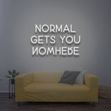 Minimalistic white 'Normal Gets You Nowhere' LED neon sign, an elegant and motivational piece for inspiring confidence and uniqueness in your space.