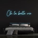 Beautiful light blue 'Oh la Belle Vie' neon sign, creating a serene atmosphere in your living room, office, or bedroom with a reminder to appreciate life's beauty.
