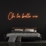 Vibrant orange 'Oh la Belle Vie' neon sign, adding a lively and colorful touch to your space, perfect for any room that needs a reminder to enjoy life's beauty.