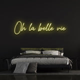 Bright yellow 'Oh la Belle Vie' neon sign, spreading happiness and positivity in any home or office, encouraging you to appreciate life's wonderful moments.