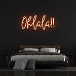 Bright orange 'Ohlala' LED neon sign, infusing a bold and cheerful touch to your décor, making a statement in any room or venue.
