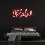 Vibrant red 'Ohlala' LED neon sign, perfect for home décor or event spaces, adding a playful and chic touch with its bold neon glow.