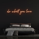 Orange 'Do What You Love' neon sign on bedroom wall, motivational light