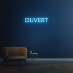 Bright 'Ouvert' LED neon sign, customizable for businesses to attract foot traffic and indicate availability.
