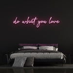Pink 'Do What You Love' neon sign in bedroom, aesthetic motivational neon light