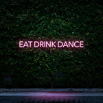 Pink LED neon sign Eat Drink Dance for minimalistic decor and social events.