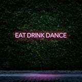 Pink LED neon sign Eat Drink Dance for minimalistic decor and social events.