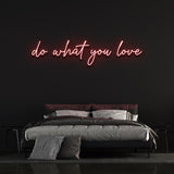 Red 'Do What You Love' neon sign glowing in a cozy bedroom