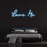 Romantic Neon Sign – 'Love Me' LED light perfect for bedroom decor or events, offering a touch of love and playful style.