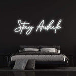 leek "Stay Awhile" LED neon sign with a warm, glowing light for creating a relaxing environment in your space.