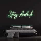 Stay Awhile" neon sign for wall decor, featuring soft LED lights that create an inviting, peaceful atmosphere.