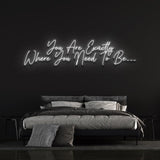  Modern bedroom with a glowing LED neon sign reading "You Are Exactly Where You Need To Be," creating a cozy and motivational ambiance.