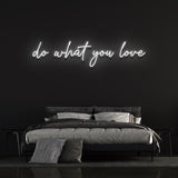 White 'Do What You Love' neon light in modern bedroom decor
