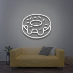 White donut LED neon sign for elegant and minimal home wall decor in a cozy living room.