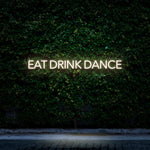 White LED neon sign Eat Drink Dance for minimalistic decor and social events.