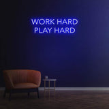Work Hard Play Hard neon sign in blue light, perfect for inspiring office decor or modern home aesthetics.
