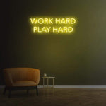 Work Hard Play Hard neon sign in lemon yellow light, perfect for inspiring office decor or modern home aesthetics.
