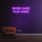 Work Hard Play Hard neon sign in purple light, perfect for inspiring office decor or modern home aesthetics.