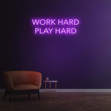 Work Hard Play Hard neon sign in purple light, perfect for inspiring office decor or modern home aesthetics.