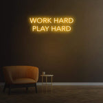 Work Hard Play Hard neon sign in yellow light, perfect for inspiring office decor or modern home aesthetics.