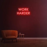 Work Harder red neon sign on a dark wall, perfect for gym or home decor, motivational LED neon sign for productivity.