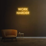 Work Harder yellow neon sign on a dark wall, perfect for gym or home decor, motivational LED neon sign for productivity.