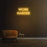 Work Harder yellow neon sign on a dark wall, perfect for gym or home decor, motivational LED neon sign for productivity.