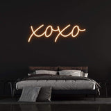 XOXO LED neon sign in vibrant green light, perfect for bedroom decor and romantic ambiance.