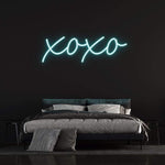 XOXO LED neon sign in vibrant white light, perfect for bedroom decor and romantic ambiance.