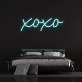 XOXO LED neon sign in vibrant white light, perfect for bedroom decor and romantic ambiance.
