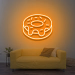 Yellow donut LED neon sign as warm vintage wall decor in a minimalistic living room.